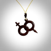 Hand carved double his and hers symbol pendant made in black jade and jasper stone. Made by NZ Pacific. Carved from black jade and red jasper stone. Free delivery worldwide.